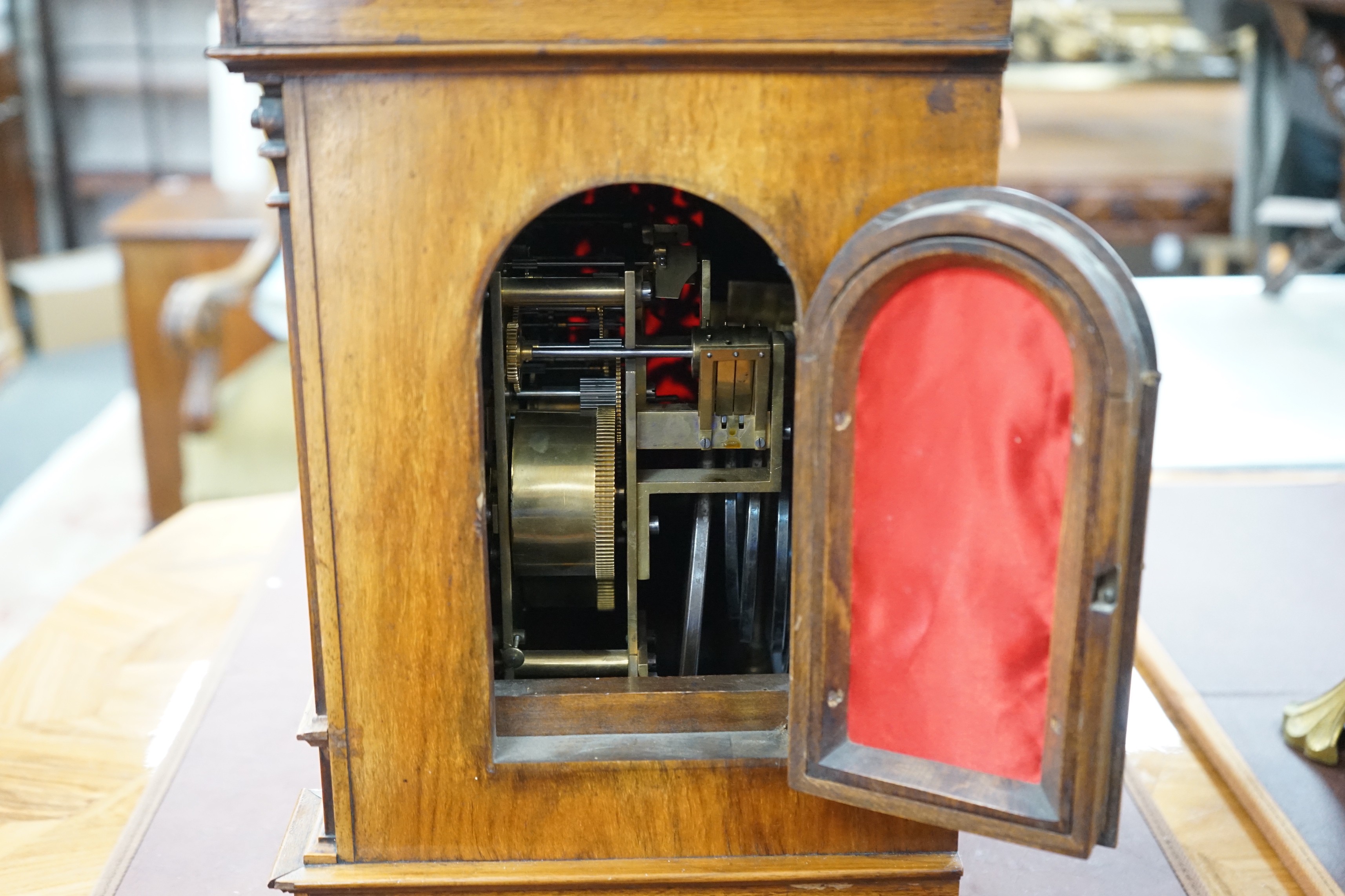 A 19th century architectural walnut bracket clock, with key and pendulum. 53cm tall